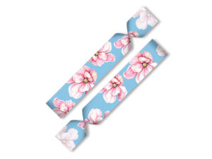 Elastic twistband hair tie and wristband with floral print on a blue background.