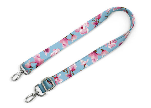 A personalized bag strap with sublimation printing. Available in two widths, adjustable length, and durable hardware. An ideal promotional accessory. AMGS Group.