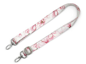 A custom bag strap with a sublimation print featuring pink flowers. Adjustable length and durable hardware. An ideal promotional accessory. AMGS Group.