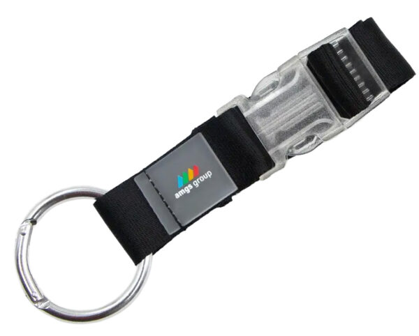 Branded Jacket Holder with clip buckle. Black mounting lanyard with connector, made of durable polyester, featuring a transparent buckle and metal shackle. An excellent promotional gadget with the option for sublimation printing. Available at AMGS Group.