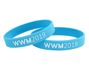Set of blue silicone wristbands with white printed logo and event branding.