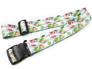 Stylish personalized luggage strap with a tropical flamingo design, combining vibrant colors and floral patterns for a chic and functional travel accessory. Made from high-quality ribbed polyester. AMGS Group.
