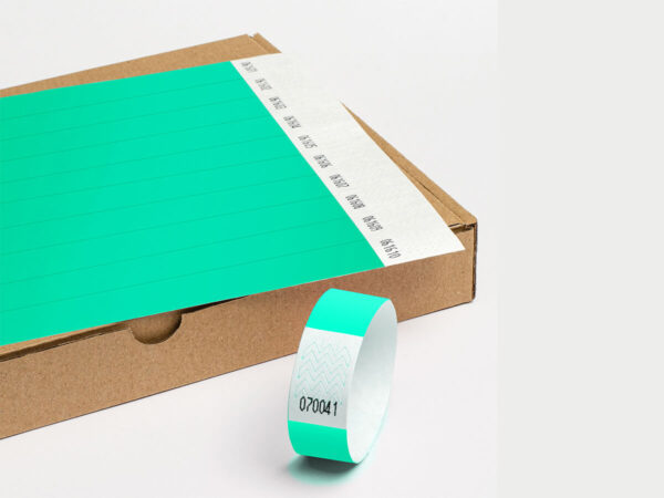 Waterproof Tyvek wristbands in aqua/teal color. Durable identification for pools and outdoor festivals. Manufacturer AMGS Group.