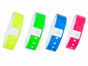 A set of vinyl wristbands in neon yellow, green, blue, and pink colors. Waterproof crowd control wristbands for mass events. Manufacturer AMGS Group.