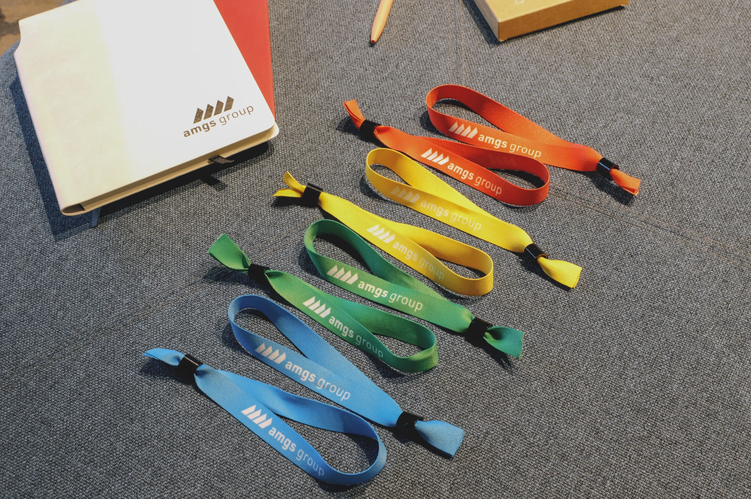 lanyards-wristbands-producer-amgs-group Colourful promotional lanyards and silicone wristbands from own production in AMGS Group factory.