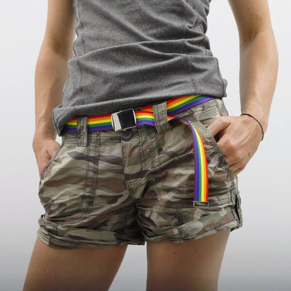 Custom belt with sublimation rainbow print and metal buckle worn with casual pants.