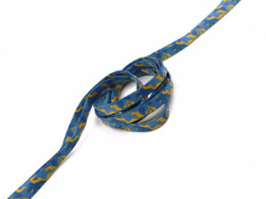 Blue tubular laces with yellow graphic pattern, rolled and unwrapped.