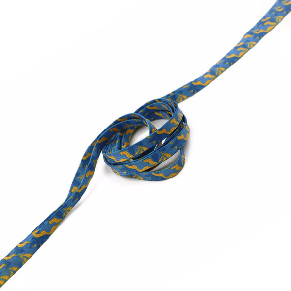 Blue tubular laces with yellow graphic pattern, rolled and unwrapped.
