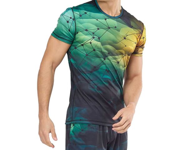 Men’s sports T-shirt presented on a model – slightly fitted cut, elastic fabric, and vivid sublimation print in shades of green, yellow, and navy with a geometric pattern. Perfect for the gym, training, and an active lifestyle. Available at AMGS Group.