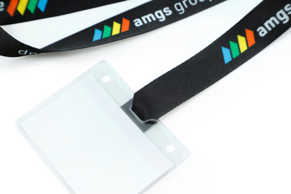 A detailed close-up shot demonstrating how the r-PET lanyard tape loops through the badge holder slot for a secure fit.