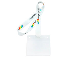 A pre-assembly view showing a white polyester lanyard with attachment slits next to a clear plastic ID holder.