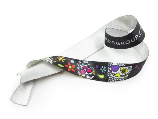 Personalized corporate ribbon 15mm showing white reverse side (one-sided print). Promotional gadget with branding. Manufacturer AMGS Group.