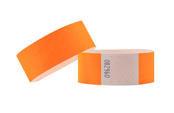 Neon orange Tyvek wristband, 25mm wide. High-visibility ID band with tamper-proof adhesive closure. Manufacturer AMGS Group.
